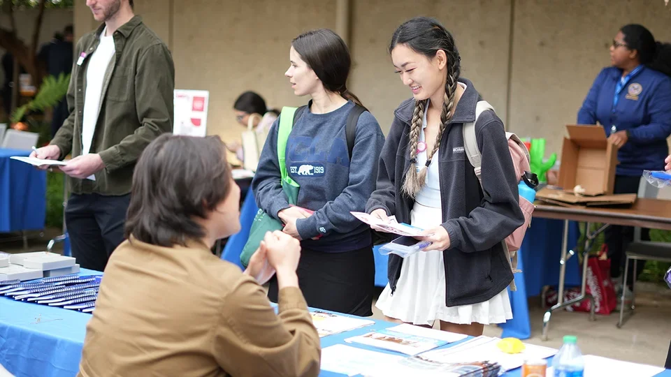 A student speaking with recruiters at the nursing event