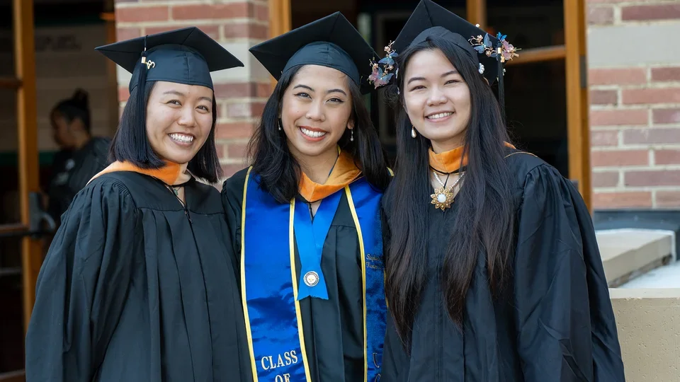 Students posing for aphoto at commencement