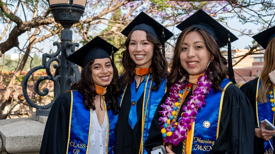 Students posing for aphoto at commencement