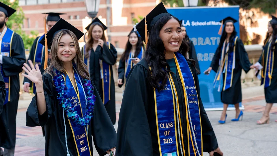 Students posing for aphoto at commencement