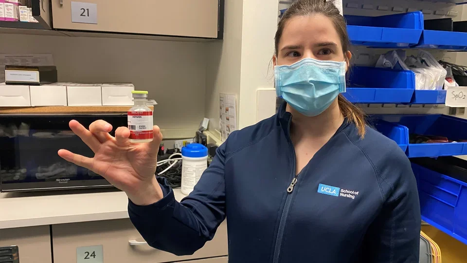 Sasha Karlin holding a vial of imitation medicine used in the simulation lab