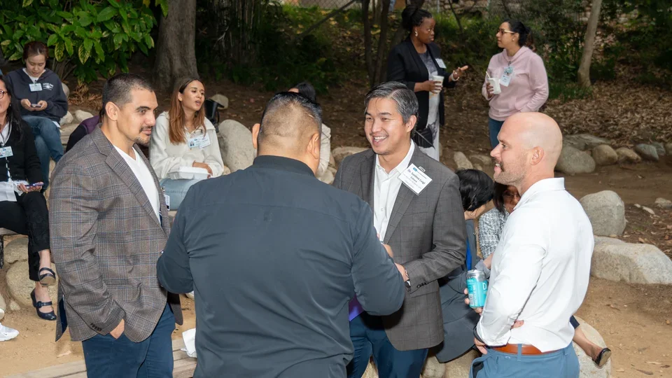 Program alumni speaking with new students