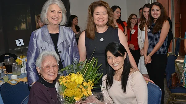 Helen Shishino (seated) with Dean Linda Sarna and daughters Laurie Shishino (seated right) and Linda Shishino-Cruz