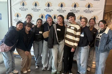 Nursing students and faculty member Beth Schwartz posing for a photograph at Midnight Mission