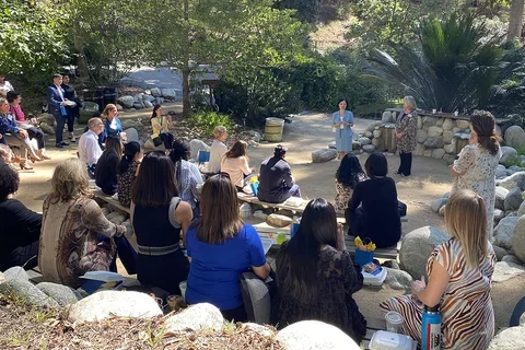 A photograph of DNP students, alumni and faculty at the Botanical Garden 