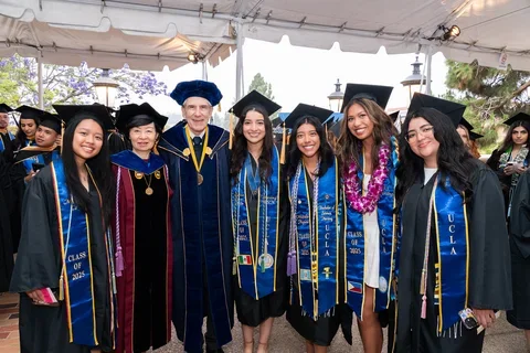 Nursing students posing with UCLA Nursing Dean Lin Zhan and UCLA Chancellor Julio Frenk