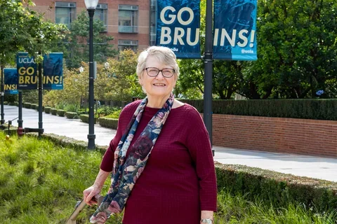 Linda Gorman on the UCLA campus with a Go Bruin sign in the background.
