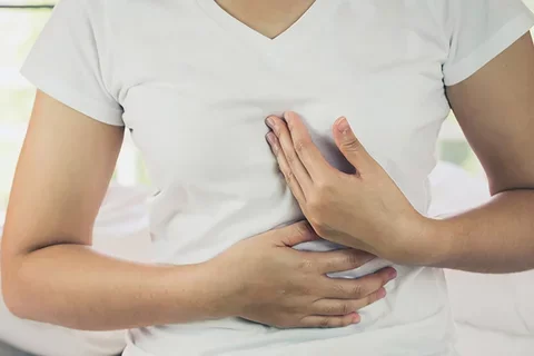 A person grabbing their chest during a heart attack