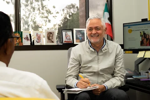 Robert Lucero sitting with a colleague at UCLA Nursing