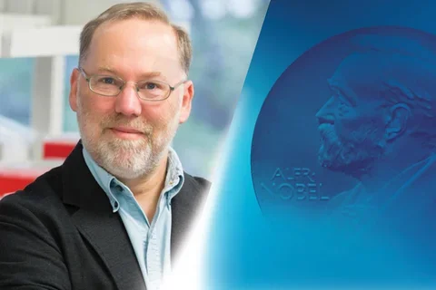 UCLA alumnus Fred Ramsdell pictured next to Nobel Prize imagery