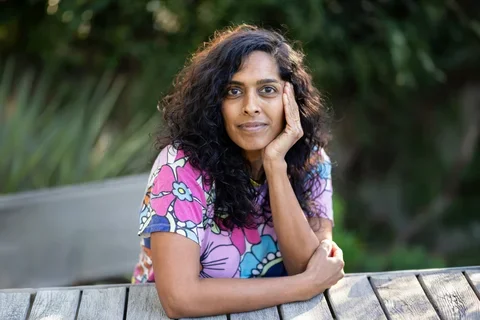 UCLA nursing student Priya Swaminathan sitting at a park bench.
