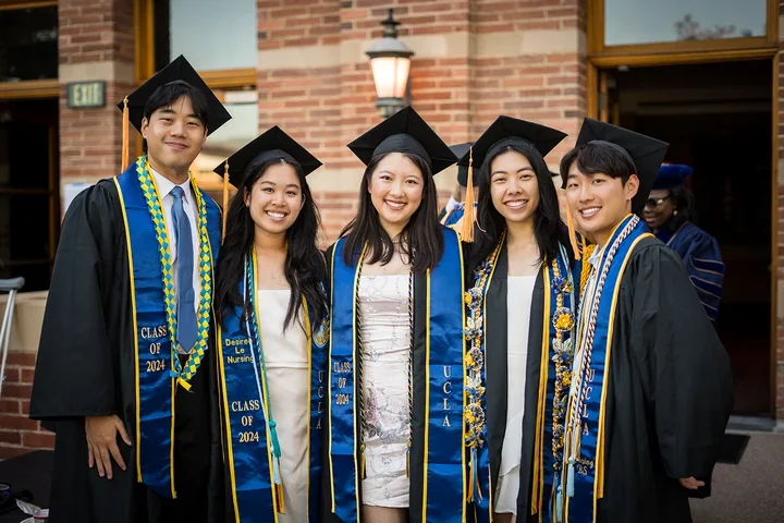 Students posing for a photograph at commencement