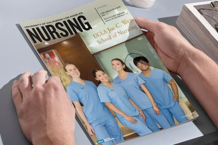 The hands of someone holding the UCLA Nursing magazine issue. 