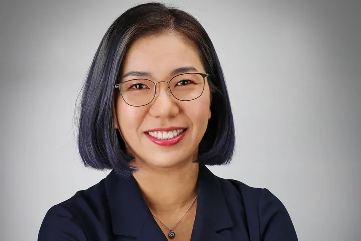 Dr. Sarah Ko headshot, wearing glasses and dark collared shirt.