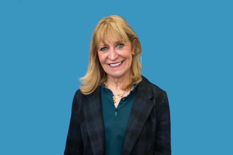 Barbara Bates-Jensen in dark grey jacket and green shirt. 