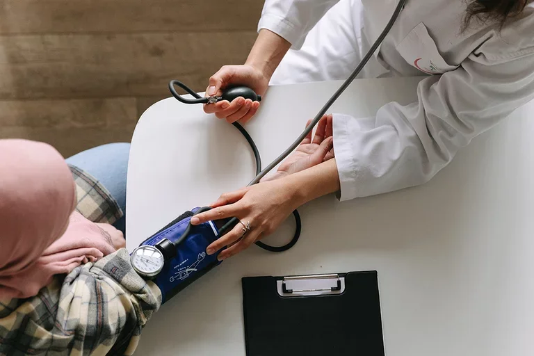 A stock image of a doctor checking blood pressure of a patient