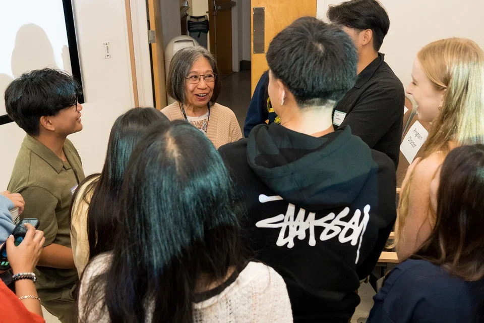 Students speakign with Emma Cuenca at the New Student Welcome