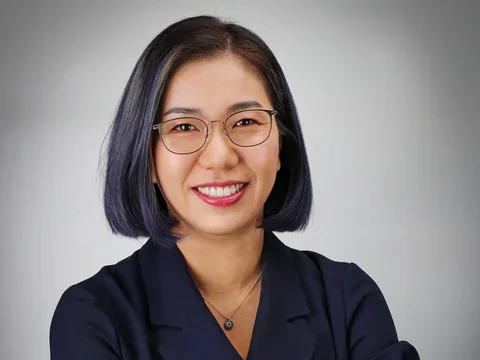 Dr. Sarah Ko headshot, wearing glasses and dark collared shirt.