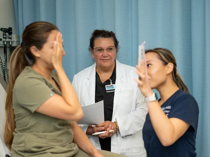 A stock image of a PhD student working with others