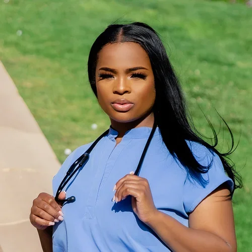 Nursing student Ariel Hale wearing blue scrubs.