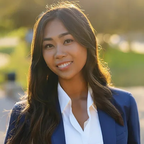 Clarissa Cabil wearing a white shirt and blue suit jacket.