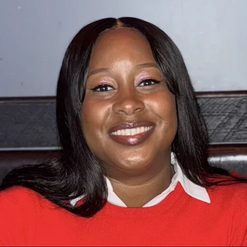 Nicole Bood wearing a red sweater.