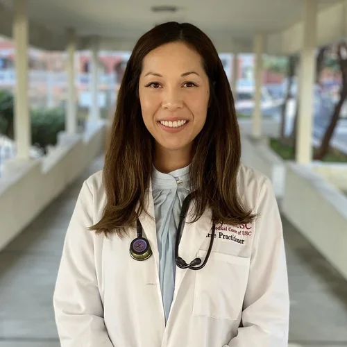 Thao Rodriguez wearing a white coat with a stethoscope around her neck.