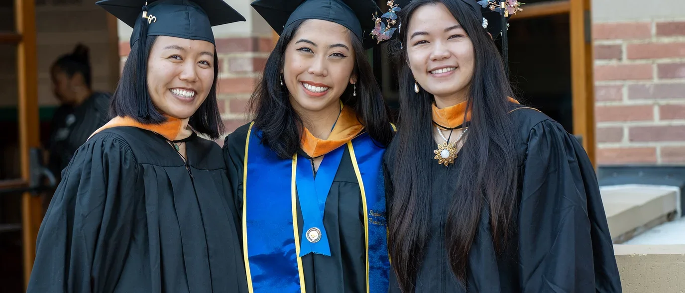 Students posing for aphoto at commencement