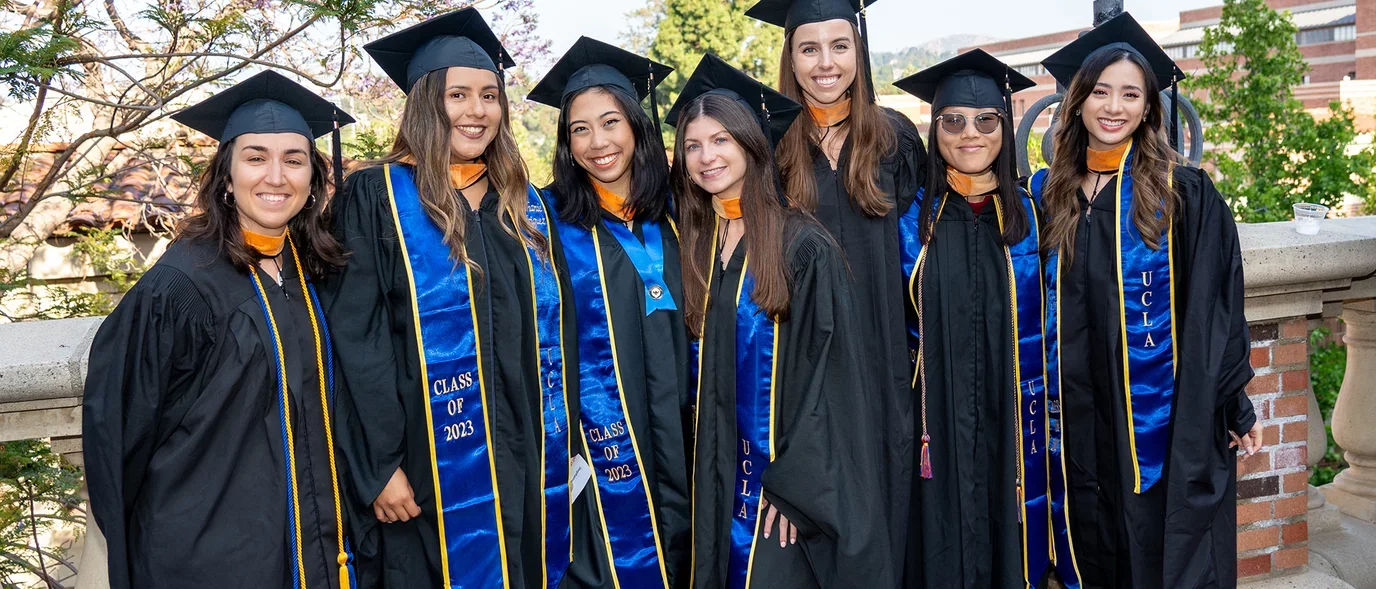 Students posing for aphoto at commencement