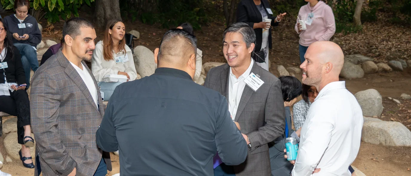 Program alumni speaking with new students