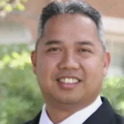 Smiling man in business suit with red tie