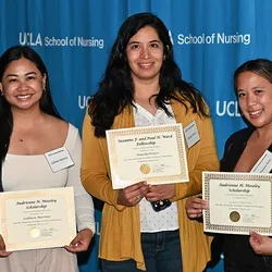 3 ucla nursing students posing for a photograph with their scholarships