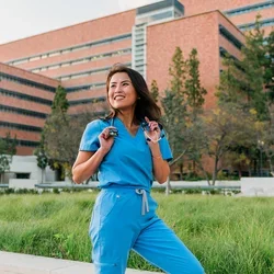 Vicky Nguyen posing in front of the CHS building