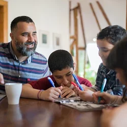 A stock photo of a dad working with his children