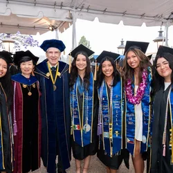 Nursing students posing with UCLA Nursing Dean Lin Zhan and UCLA Chancellor Julio Frenk