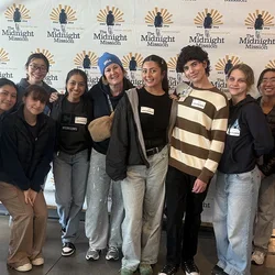 Nursing students and faculty member Beth Schwartz posing for a photograph at Midnight Mission