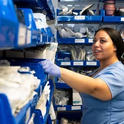 A nursing student getting supplies from the Simulation Lab supply room