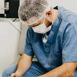 A male nurse with his head down