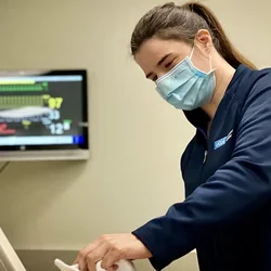 Nursing staff member Sasha Karlin cleaning a simulation mannequin. 