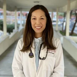 Thao Rodriguez wearing a white coat with a stethoscope around her neck.