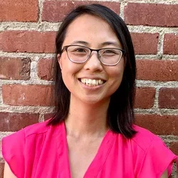 Women with glasses wearing a pink shirt