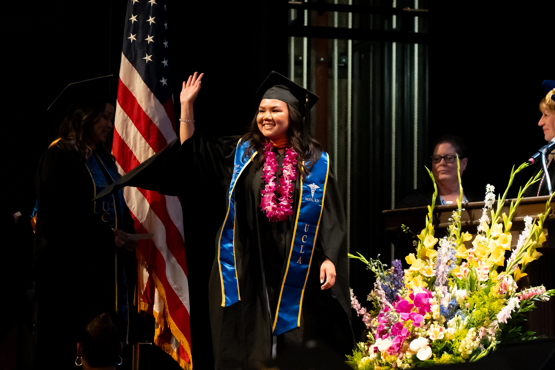 A student walking across the commencement stage