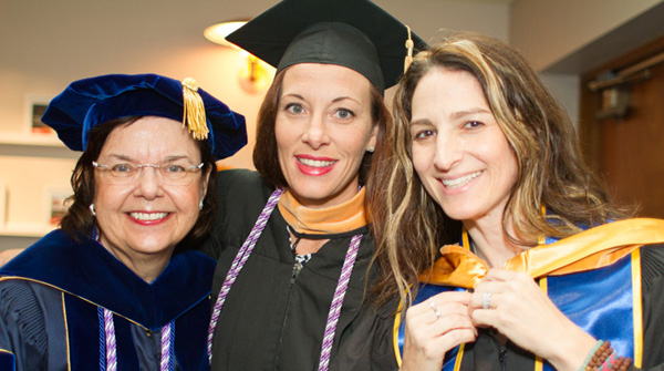 Three nursing faculty wearing academic regalia