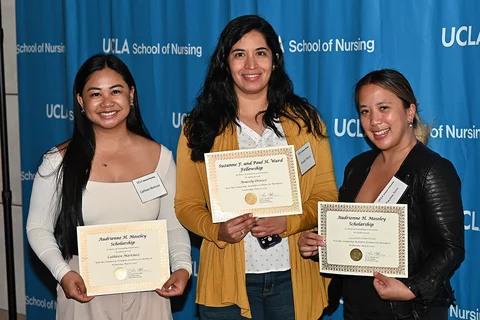 3 ucla nursing students posing for a photograph with their scholarships