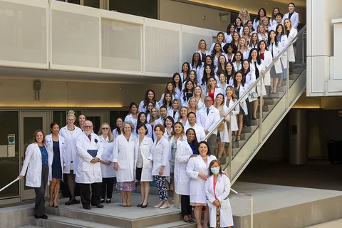 APRN students and faculty gathered in their White Coats