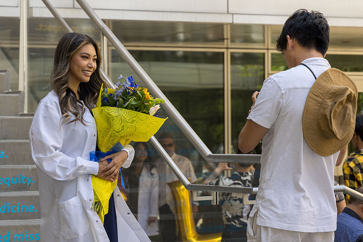 An APRN student having a photo taken at the White Coat ceremony