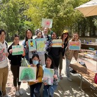 A group of students posing for a photo while holding the art they created during Sunshine & Color