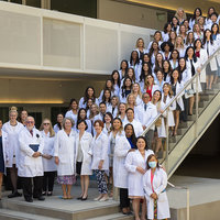 APRN students and faculty gathered in their White Coats